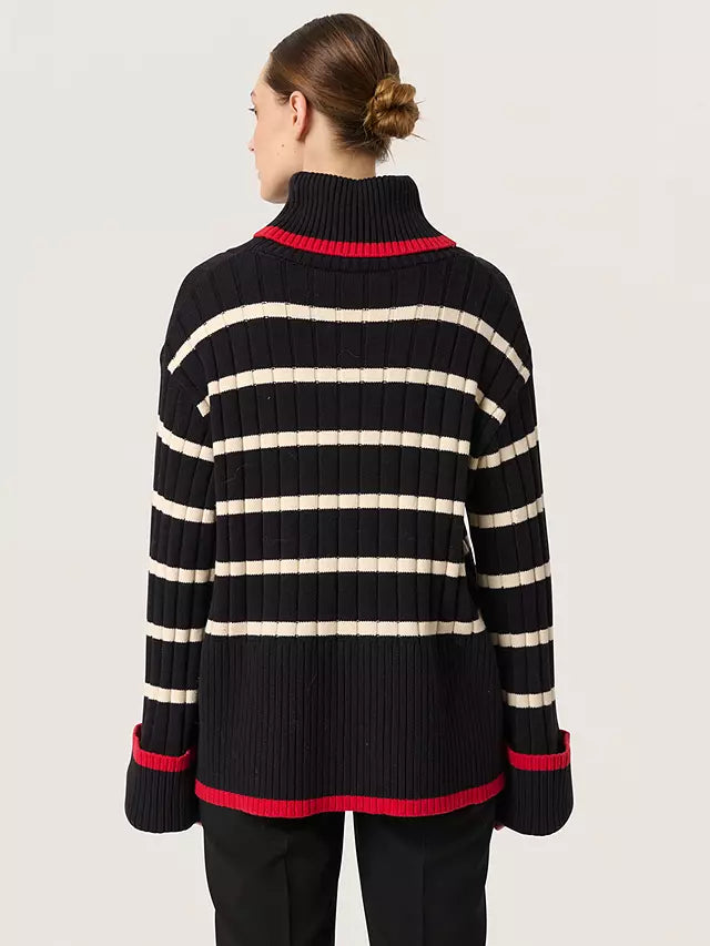 Stay cozy and stylish this autumn with our Soaked in Luxury musling ribbed rollneck jumper! Made with a chunky ribbed knit, this jumper is perfect for chilly weather. The bold red accents add a pop of colour to any outfit, making you stand out in the best way. Stay warm and chic this season with our must-have jumper.



Made of 72% cotton, 28% polyester, Machine wash 30 and air dry where possible, low iron if needed&nbsp;
