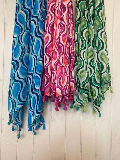 Wrap yourself in colour and have fun with our Vivaldi Scarf! Featuring retro abstract swirls in your choice of pink, blue, or green. The lightweight design and playful tassels make this scarf a must-have for adding a pop of energy to any outfit. Elevate your style with our Vivaldi Scarf!    Made of 50% viscose, 50% cotton, Machine wash 30 and low iron only&nbsp;