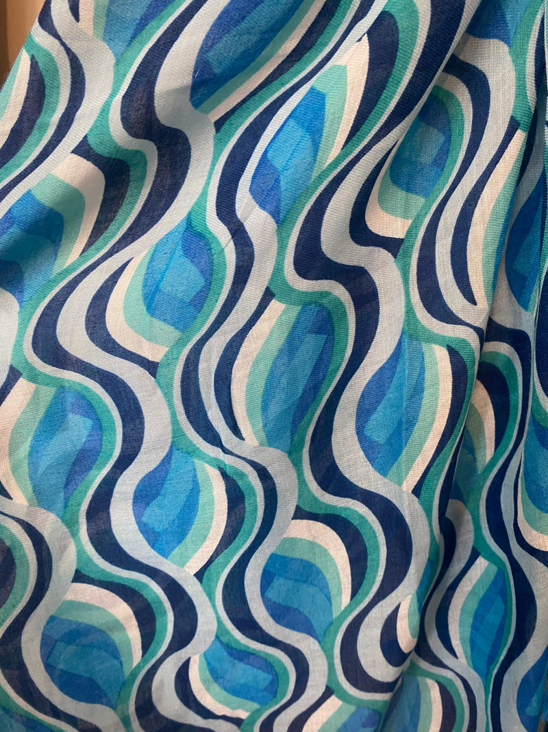 Wrap yourself in colour and have fun with our Vivaldi Scarf! Featuring retro abstract swirls in your choice of pink, blue, or green. The lightweight design and playful tassels make this scarf a must-have for adding a pop of energy to any outfit. Elevate your style with our Vivaldi Scarf!    Made of 50% viscose, 50% cotton, Machine wash 30 and low iron only&nbsp;