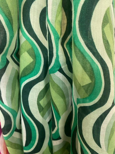 Wrap yourself in colour and have fun with our Vivaldi Scarf! Featuring retro abstract swirls in your choice of pink, blue, or green. The lightweight design and playful tassels make this scarf a must-have for adding a pop of energy to any outfit. Elevate your style with our Vivaldi Scarf!    Made of 50% viscose, 50% cotton, Machine wash 30 and low iron only&nbsp;