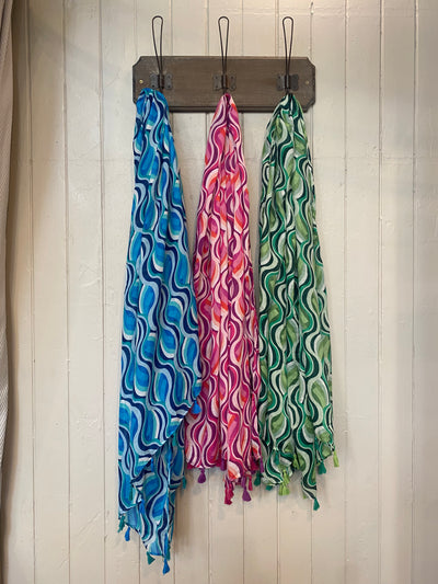 Wrap yourself in colour and have fun with our Vivaldi Scarf! Featuring retro abstract swirls in your choice of pink, blue, or green. The lightweight design and playful tassels make this scarf a must-have for adding a pop of energy to any outfit. Elevate your style with our Vivaldi Scarf!    Made of 50% viscose, 50% cotton, Machine wash 30 and low iron only&nbsp;
