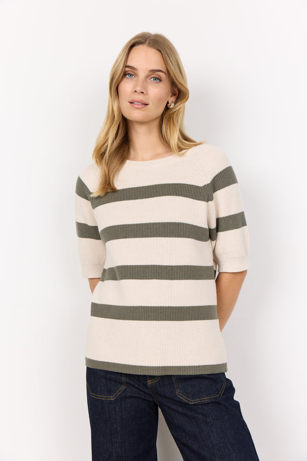 Front view of model wearing soyaconcept short sleeved, round neck Kanita top loose over jeans. This top has a cream background with thick horizontal stripes in khaki 